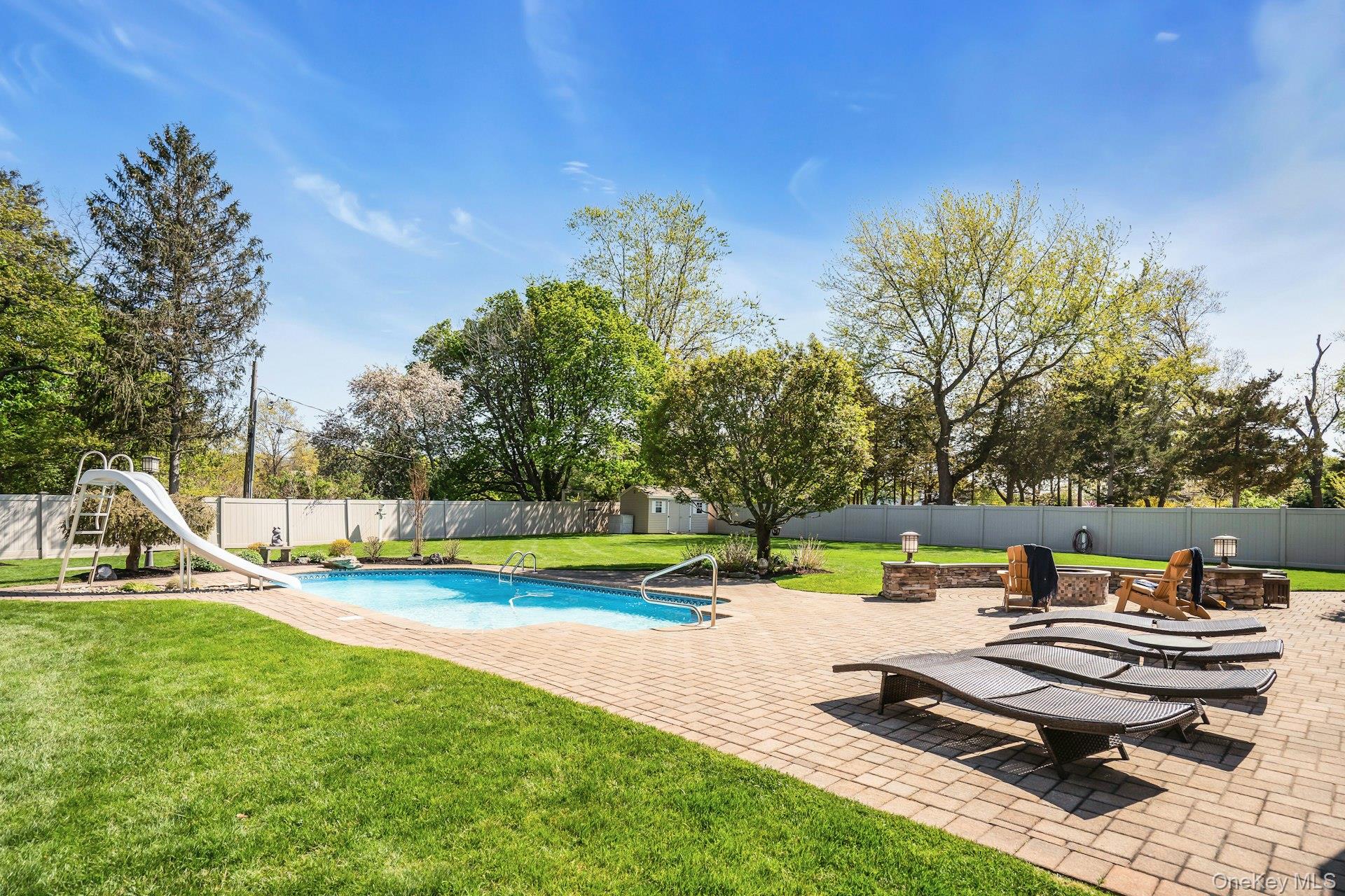 101 Hayrick Lane Commack, NY 11725 - Photo 45 of 50 a view of a swimming pool with lounge chairs in patio