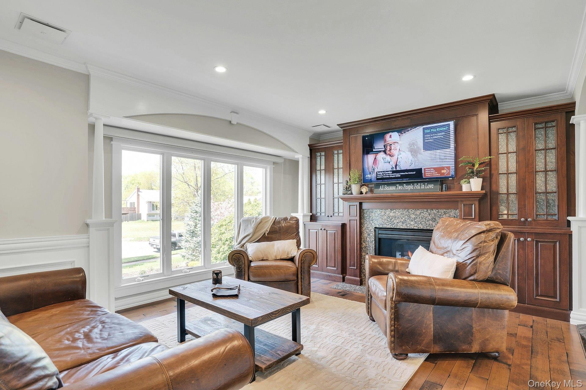 101 Hayrick Lane Commack, NY 11725 - Photo 6 of 50 a living room with furniture a flat screen tv and a fireplace