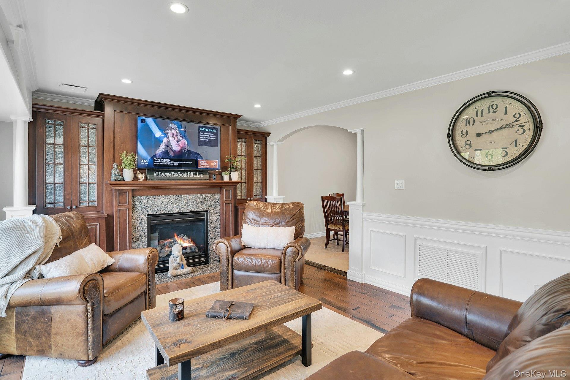 101 Hayrick Lane Commack, NY 11725 - Photo 7 of 50 a living room with furniture a clock and a fireplace