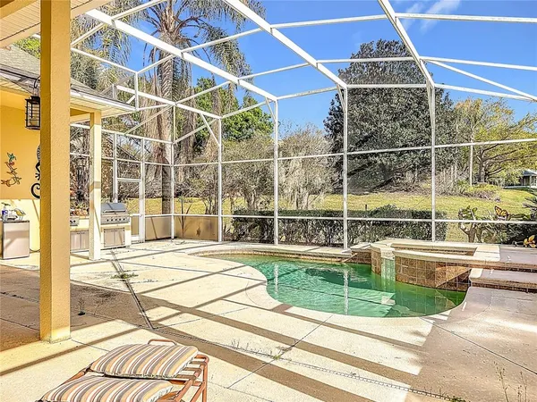 a view of a backyard patio with swimming pool