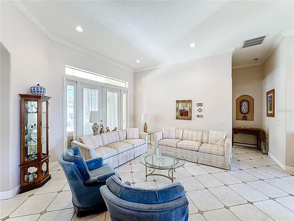 a view of a dining room with furniture and chandelier