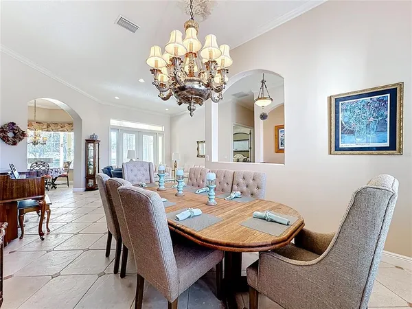 a view of a dining room with furniture and chandelier