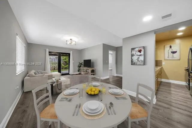 a view of a dining room with furniture and wooden floor