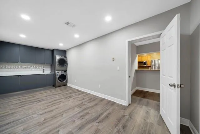 a view of a kitchen with a sink and a refrigerator