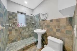 a bathroom with a sink mirror and toilet