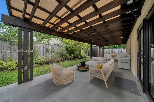 a view of a patio with table and chairs potted plants with wooden floor and fence