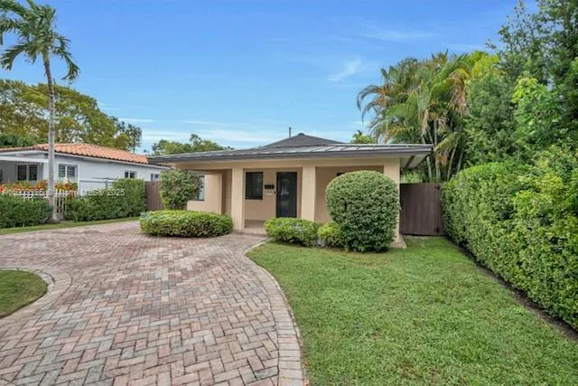 a front view of a house with garden