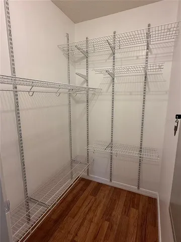 a view of a room with wooden floor