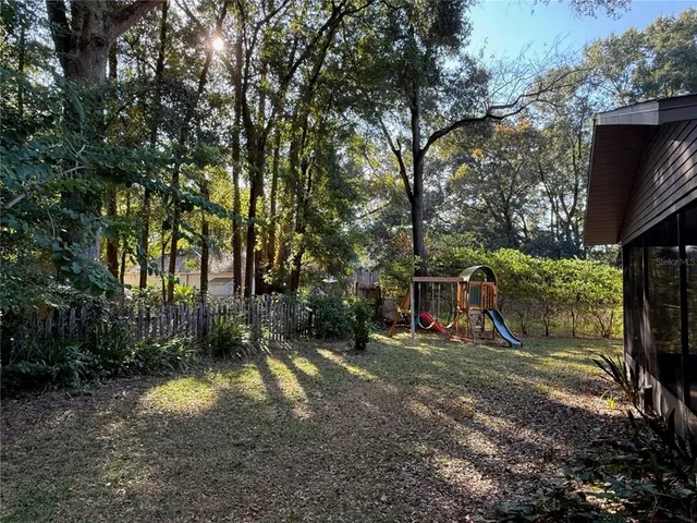 a view of a yard with large trees