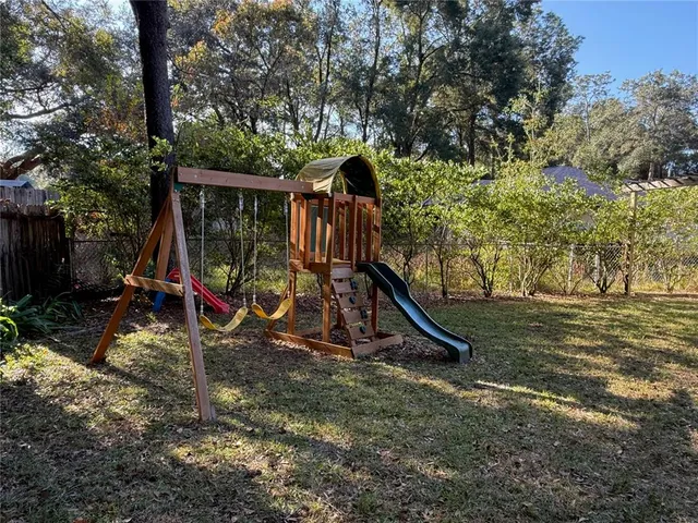 a view of outdoor space with trees and playing ground