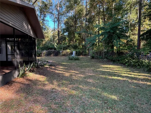 a view of a street with a bench and trees