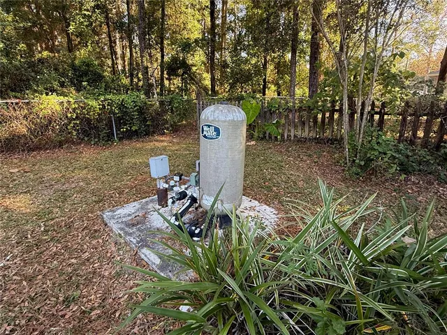 a backyard of a house with table and chairs