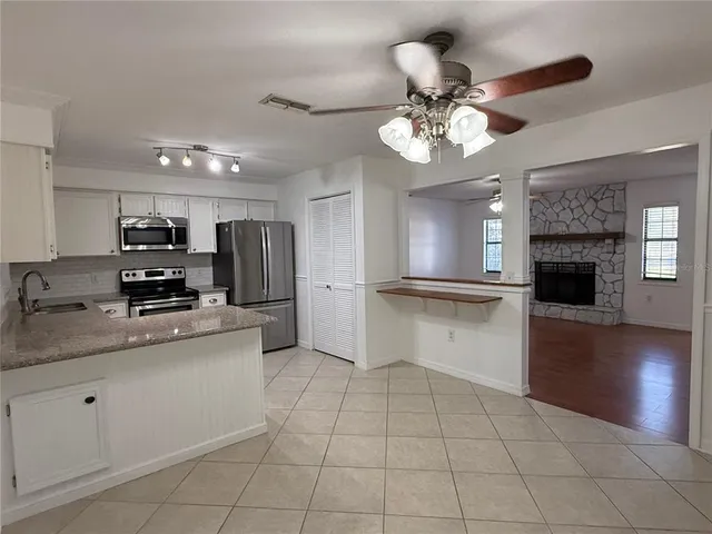 a kitchen with a stove a sink and a refrigerator