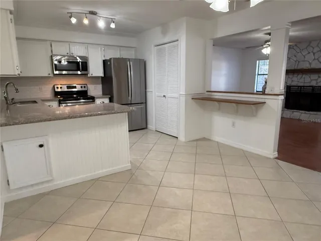 a kitchen with stainless steel appliances a refrigerator sink and cabinets