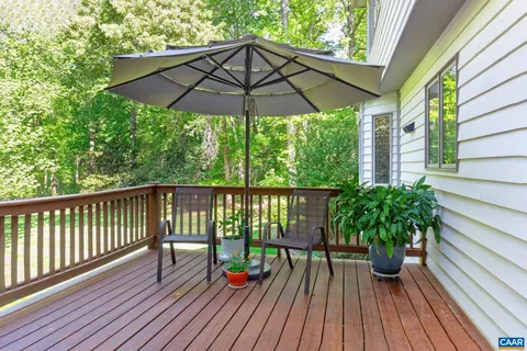 a view of balcony with wooden floor and umbrella
