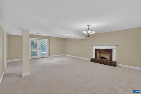 a spacious bedroom with a bed and a chandelier