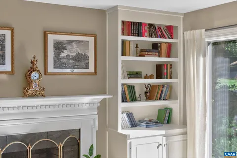 a living room with lots of books and a book shelf