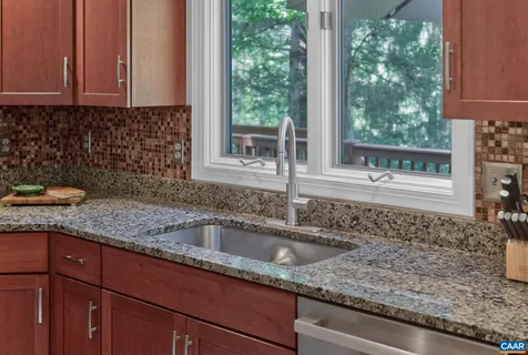 a kitchen with granite countertop a sink and a window