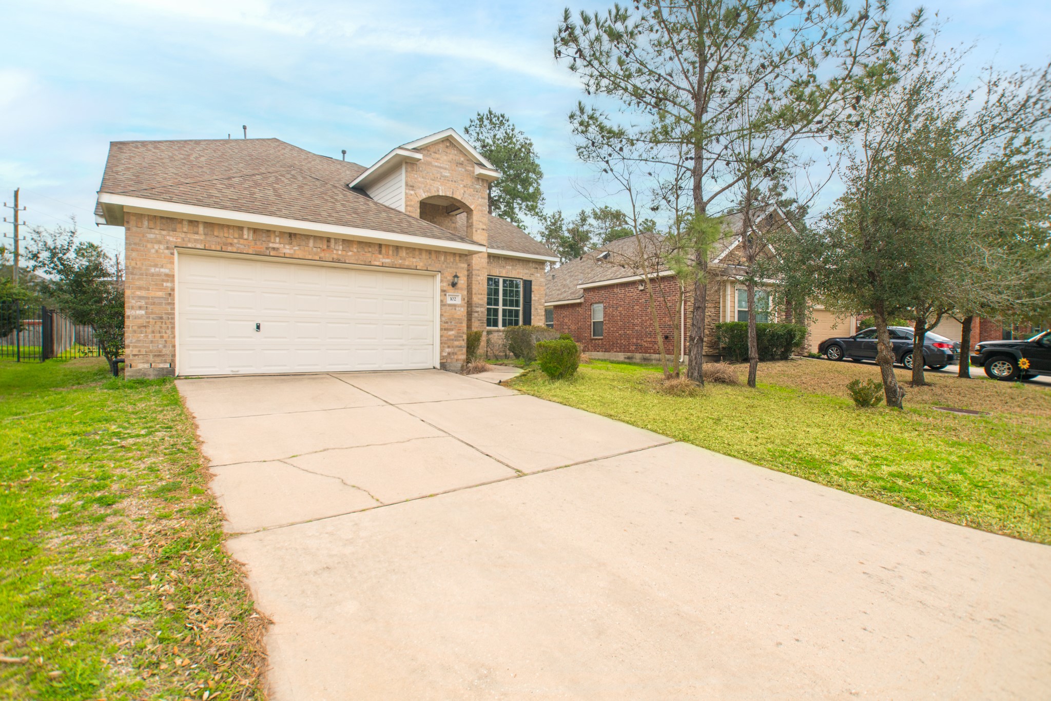 a front view of a house with a yard and trees