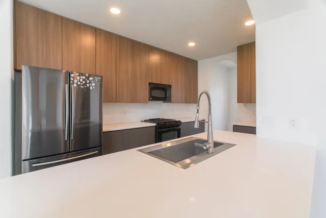 a kitchen with stainless steel appliances a refrigerator and a stove