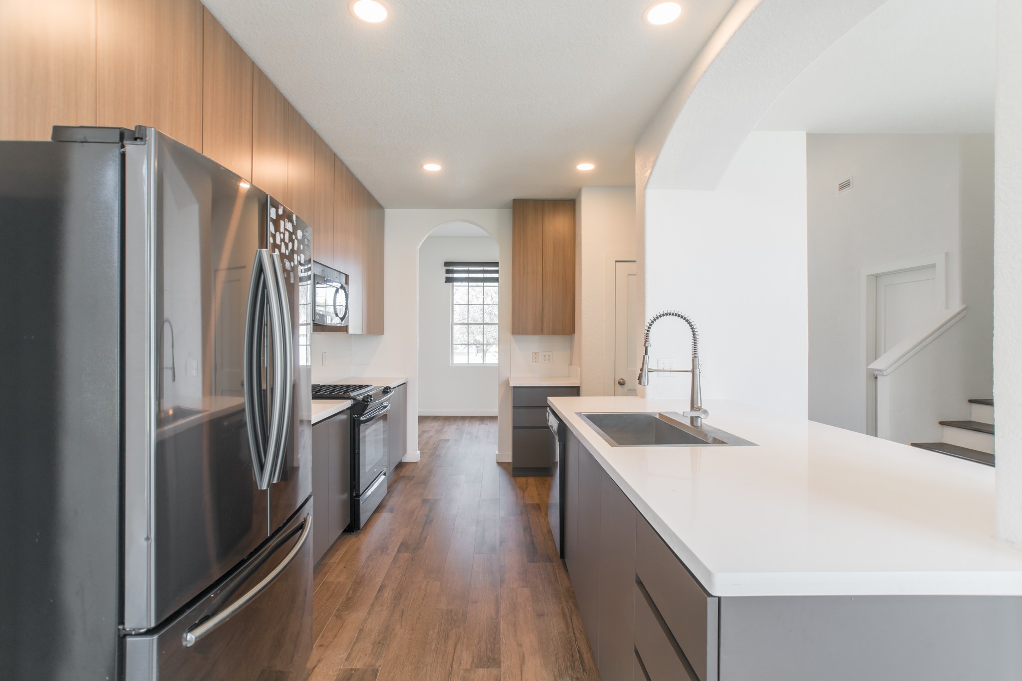 102 East Lasting Spring Circle Spring, TX 77389 - Photo 18 of 45 a kitchen with stainless steel appliances a sink stove and refrigerator