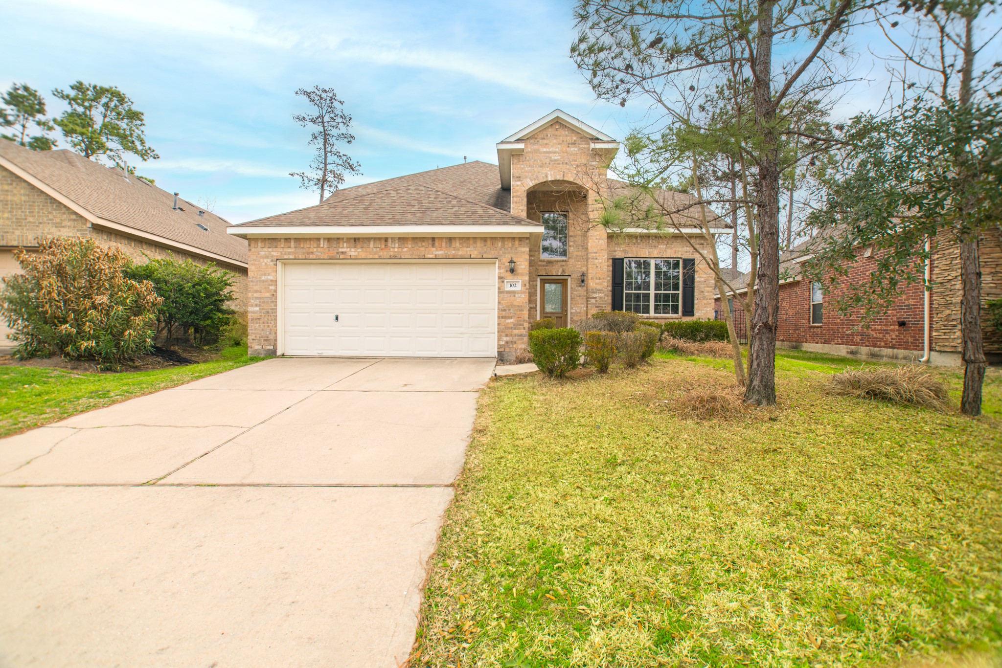 102 East Lasting Spring Circle Spring, TX 77389 - Photo 2 of 45 a front view of a house with a yard and garage