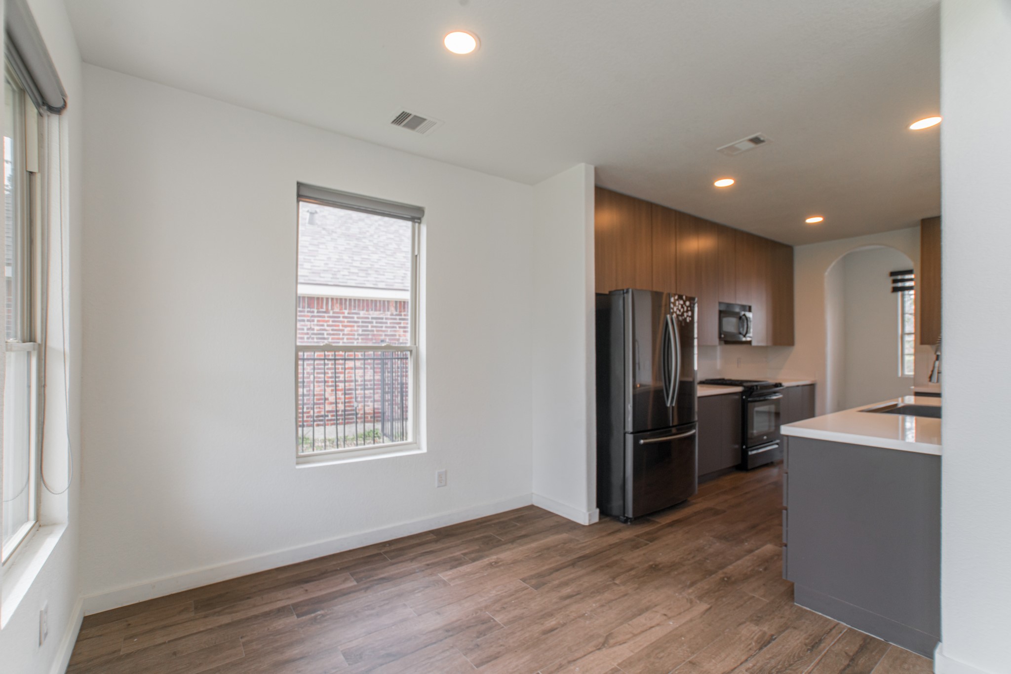102 East Lasting Spring Circle Spring, TX 77389 - Photo 22 of 45 a view of a kitchen with refrigerator and wooden floor