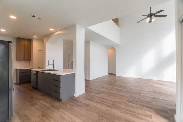 a large white room with kitchen island in the center