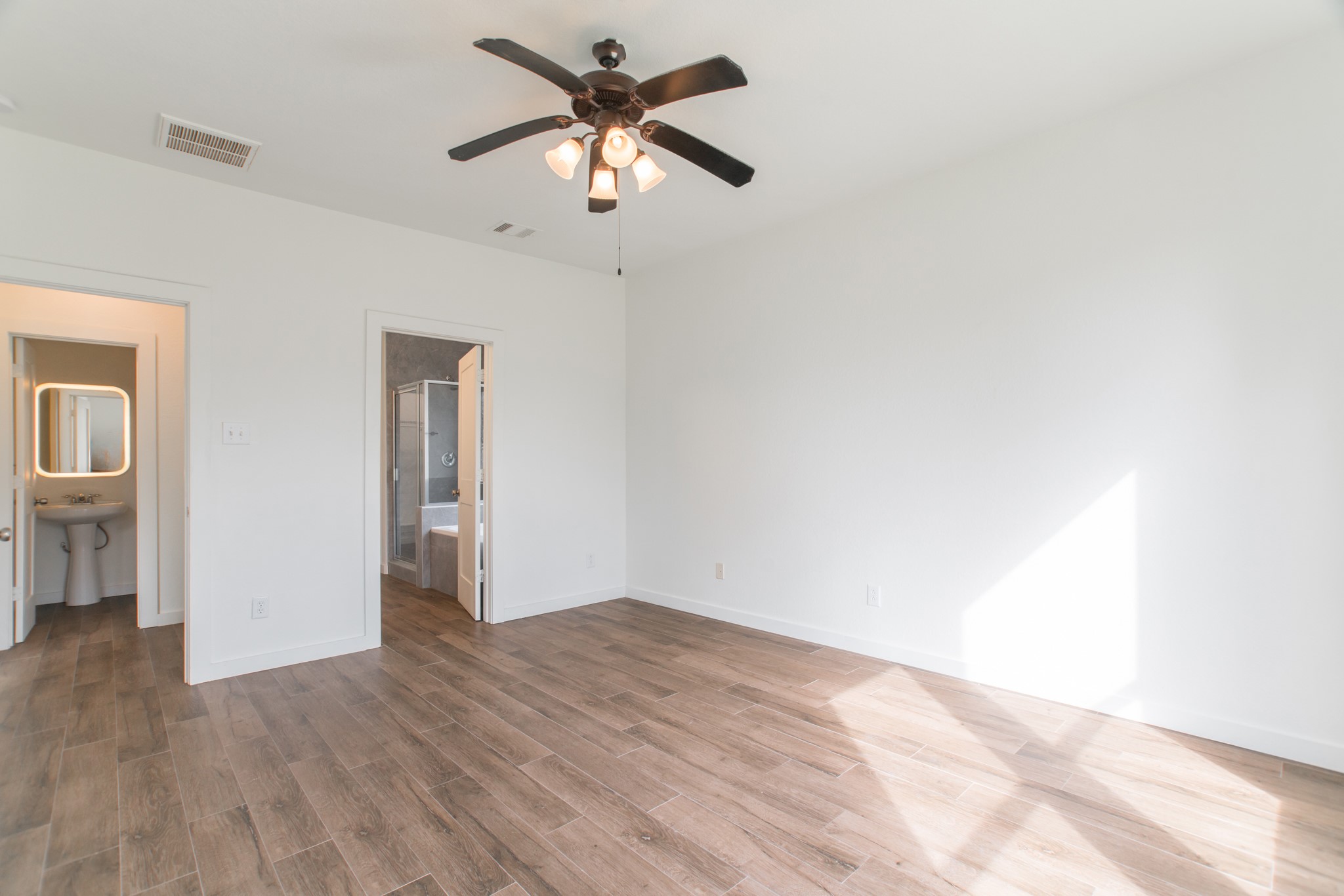 102 East Lasting Spring Circle Spring, TX 77389 - Photo 25 of 45 an empty room with wooden floor chandelier fan and windows