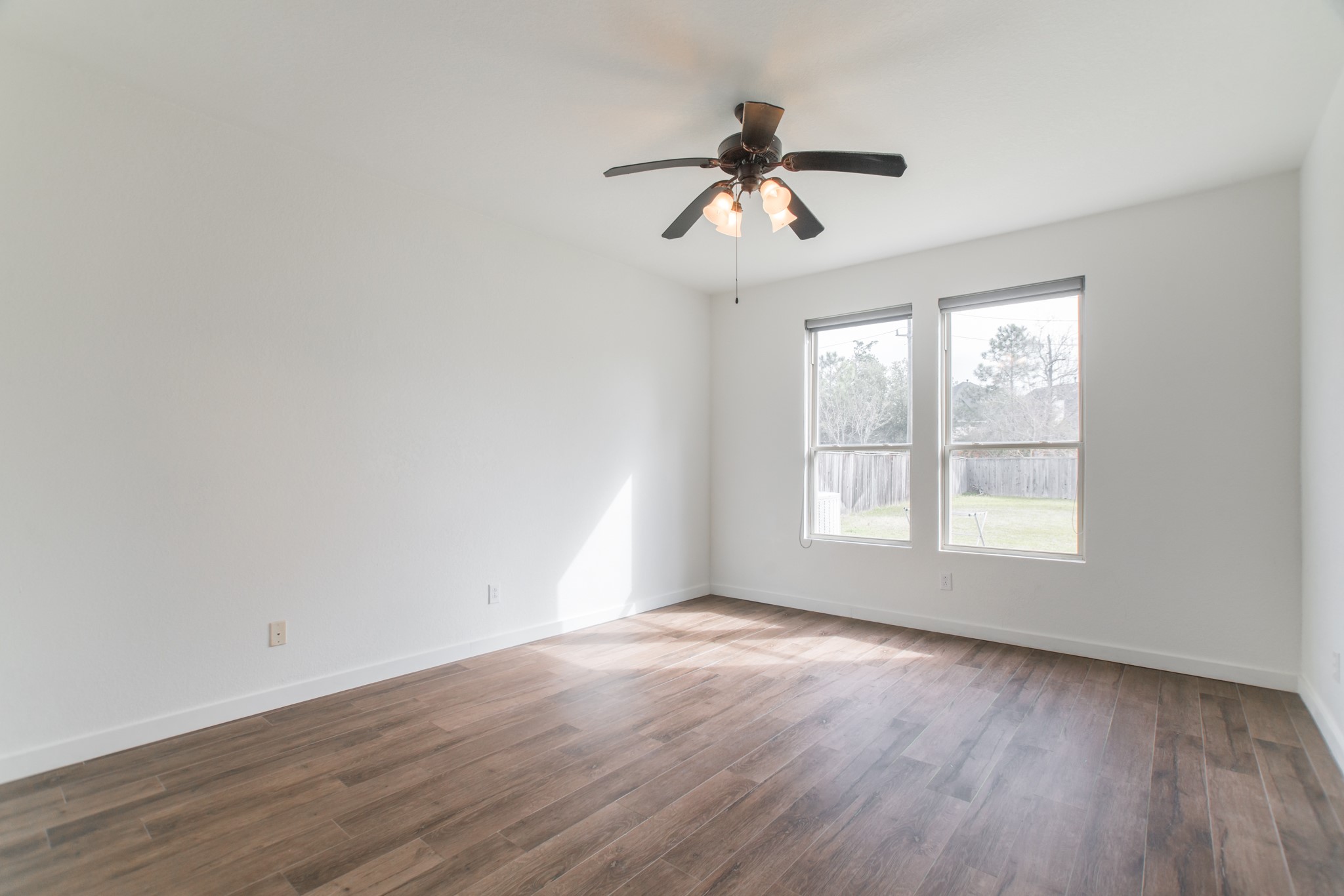 102 East Lasting Spring Circle Spring, TX 77389 - Photo 26 of 45 a view of an empty room with wooden floor and a window