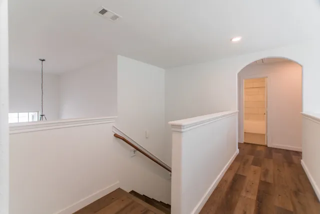 a view of hallway with wooden floor