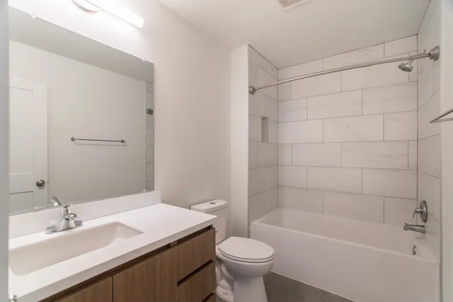 a bathroom with a sink a toilet and bathtub