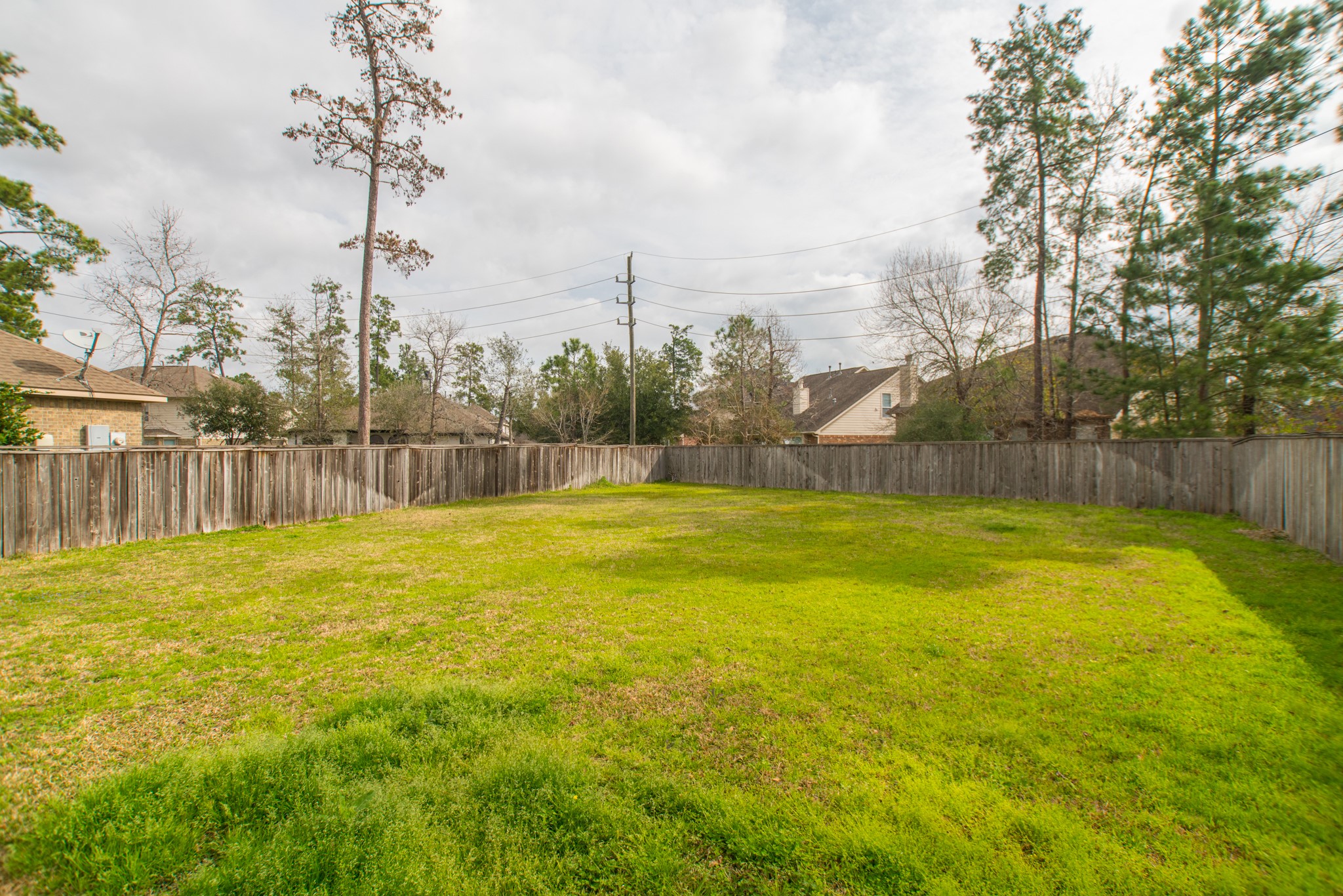 102 East Lasting Spring Circle Spring, TX 77389 - Photo 43 of 45 a view of a swimming pool with a yard and a wooden fence