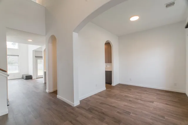 a view of a room with wooden floor and a window