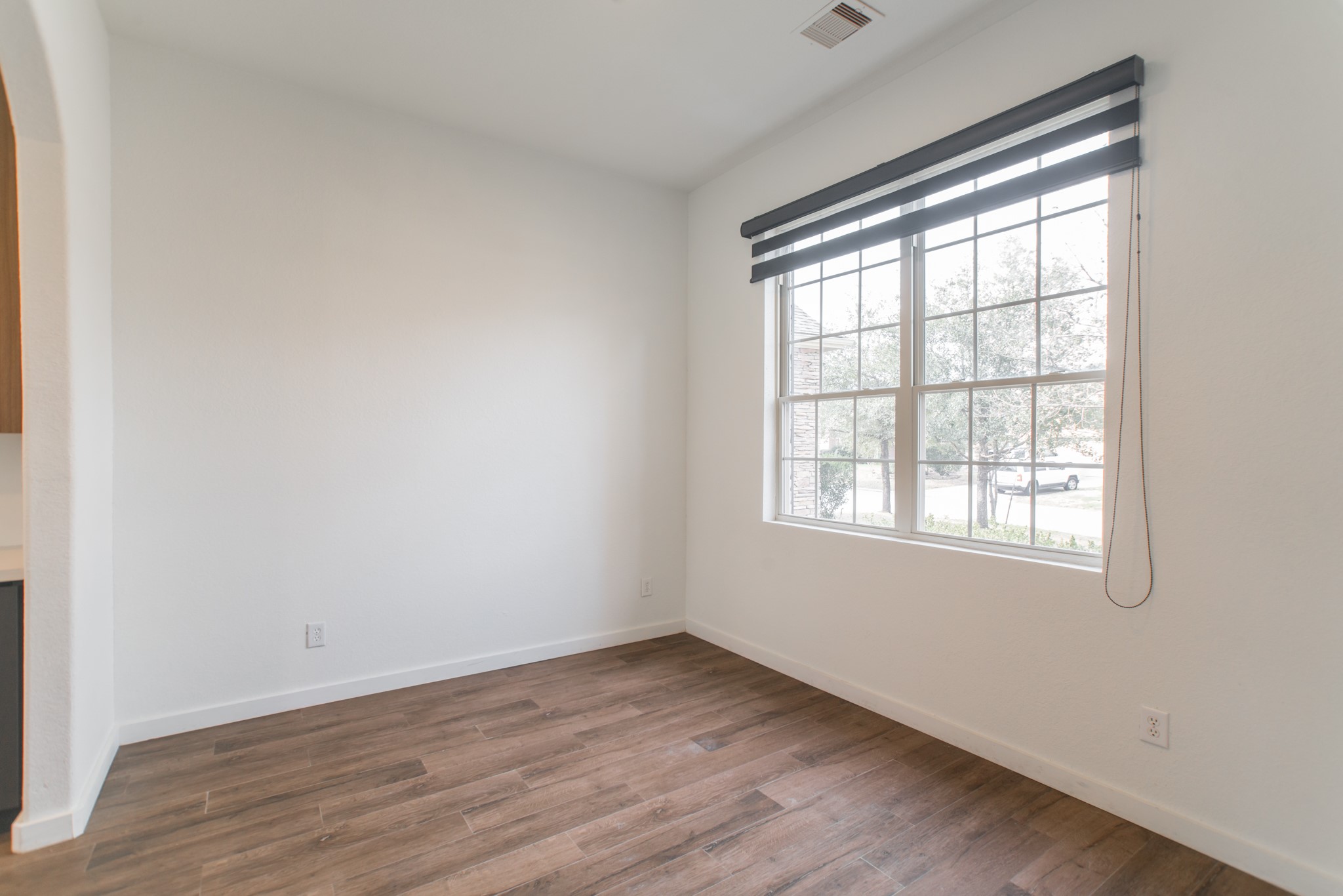 102 East Lasting Spring Circle Spring, TX 77389 - Photo 7 of 45 an empty room with wooden floor and windows