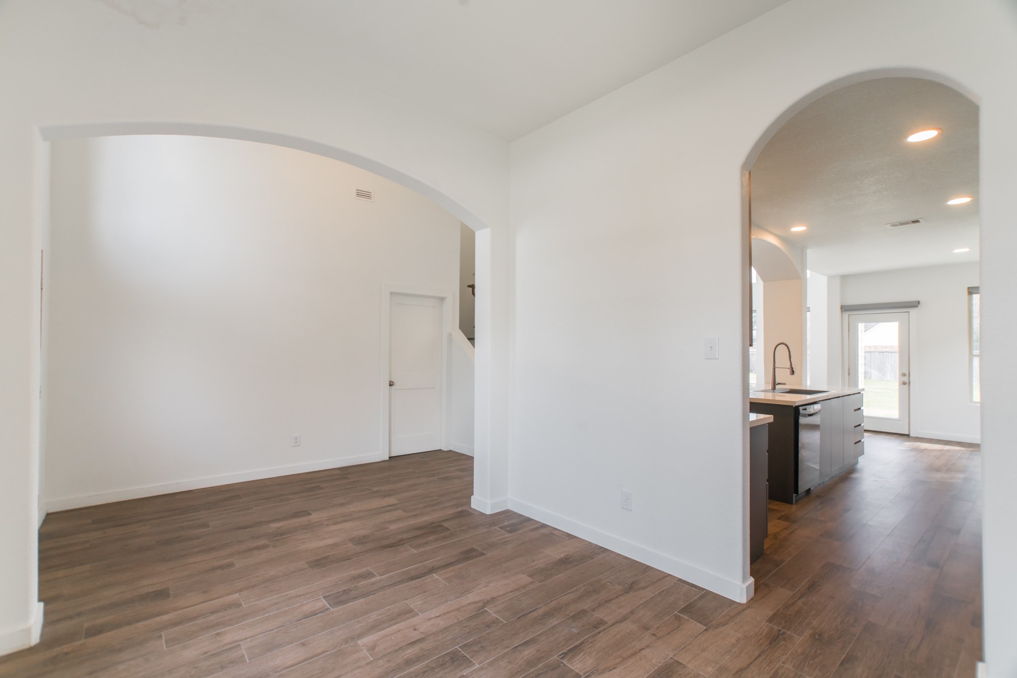 102 East Lasting Spring Circle Spring, TX 77389 - Photo 8 of 45 a view of a big room with wooden floor and a kitchen