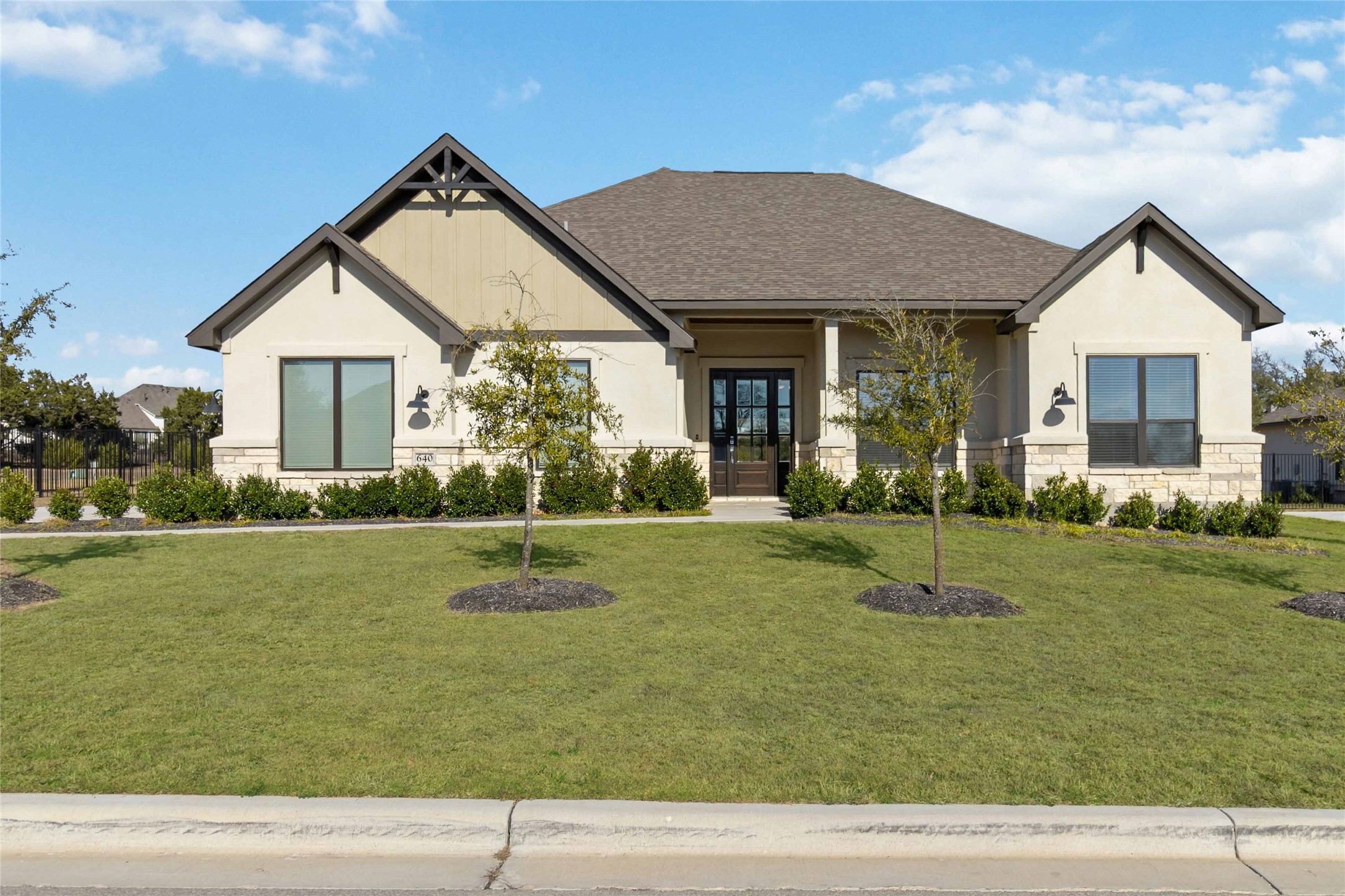 640 Prairie Clover Drive Dripping Springs, TX 78620 - Photo 1 of 32 View of front of property with stone siding, a front lawn, roof with shingles, and stucco siding
