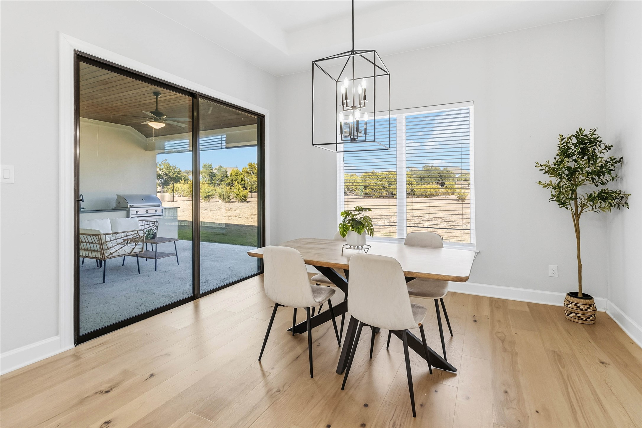 640 Prairie Clover Drive Dripping Springs, TX 78620 - Photo 11 of 32 Dining space with light wood-style flooring, healthy amount of natural light, a chandelier, and ceiling fan
