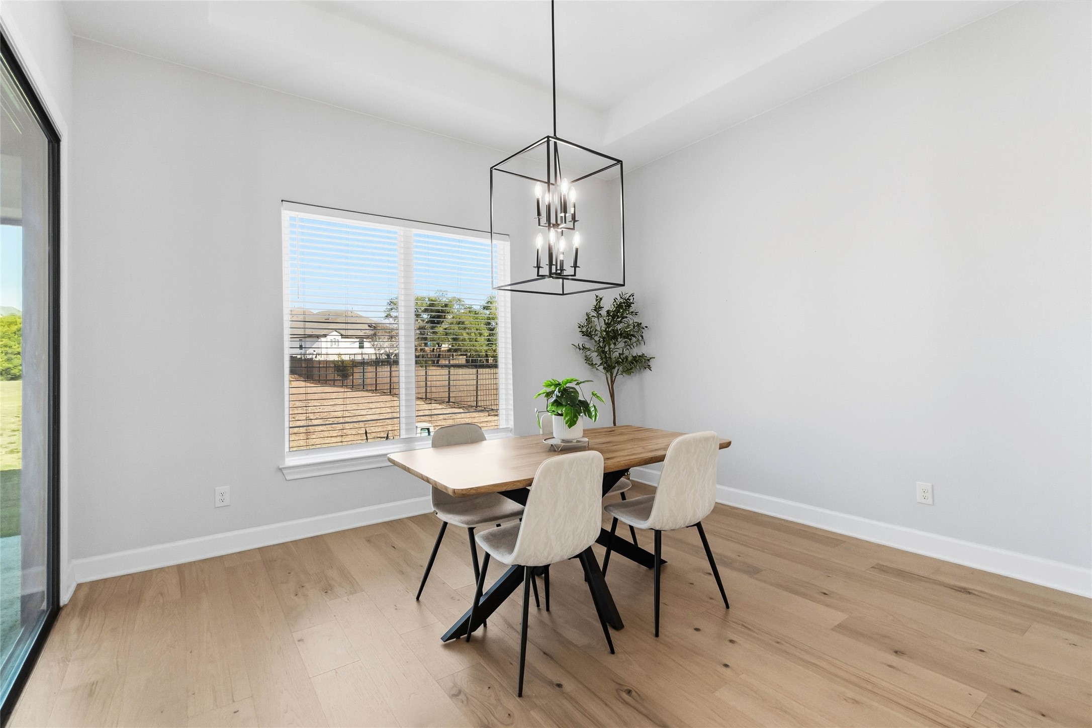 640 Prairie Clover Drive Dripping Springs, TX 78620 - Photo 12 of 32 Dining area featuring light wood-type flooring and a chandelier