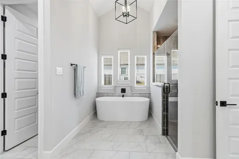 a spacious bathroom with a bathtub and a shower