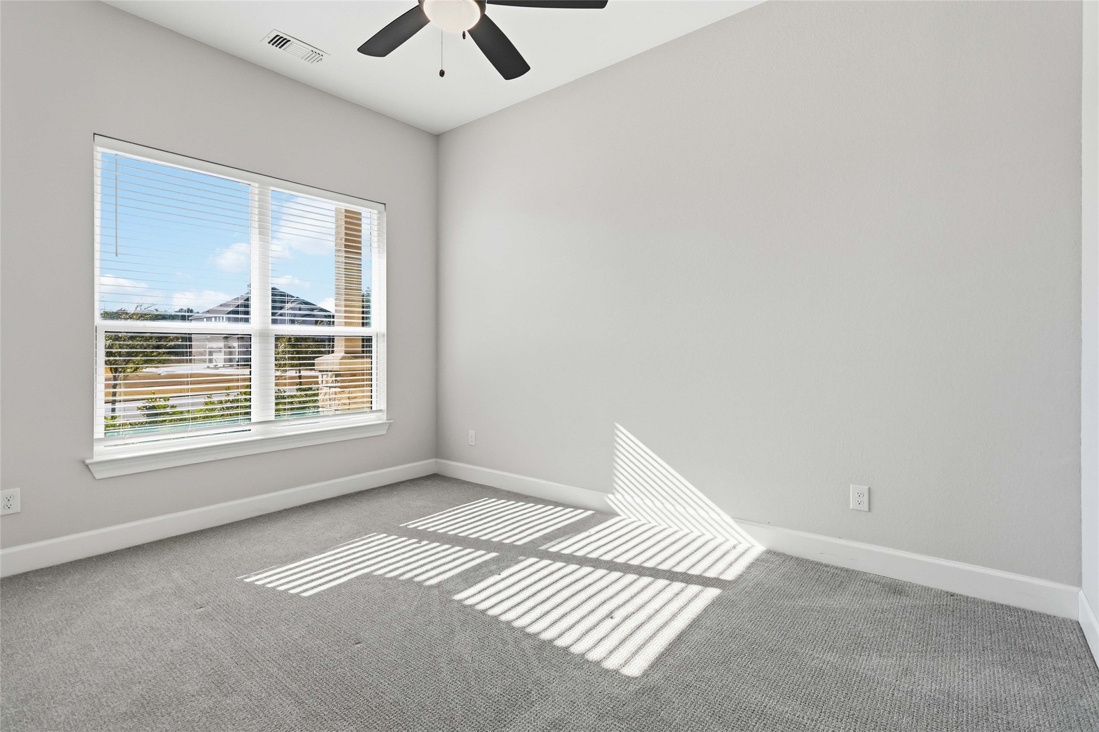 640 Prairie Clover Drive Dripping Springs, TX 78620 - Photo 22 of 32 Carpeted spare room featuring baseboards and ceiling fan