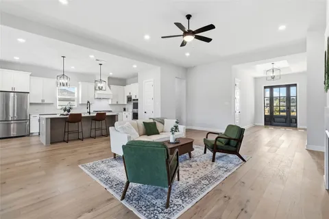 a living room with lots of furniture and kitchen view