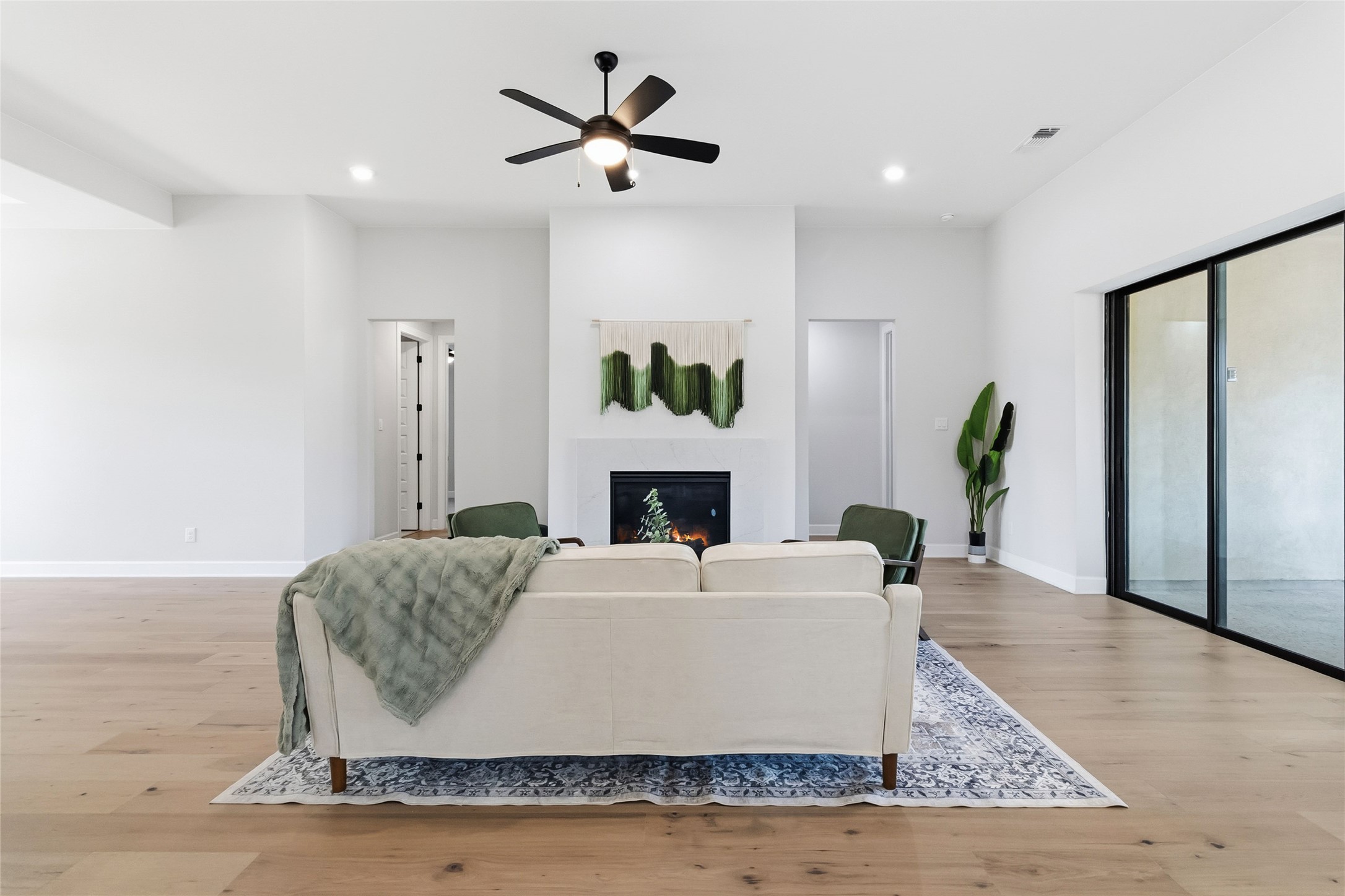 640 Prairie Clover Drive Dripping Springs, TX 78620 - Photo 6 of 32 Living area with a premium fireplace, light wood finished floors, ceiling fan, and recessed lighting