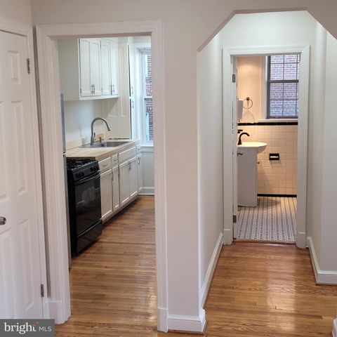 a kitchen with granite countertop white cabinets and stainless steel appliances