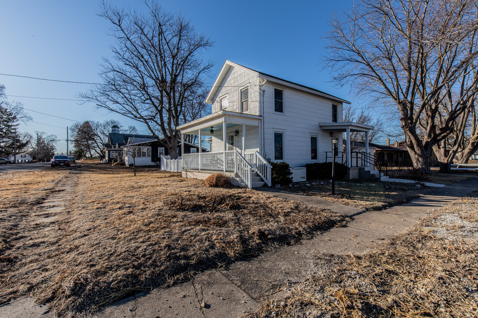 220 2nd Street Wyanet, IL 61379 - Photo 3 of 27 a front view of a house with a yard covered in snow
