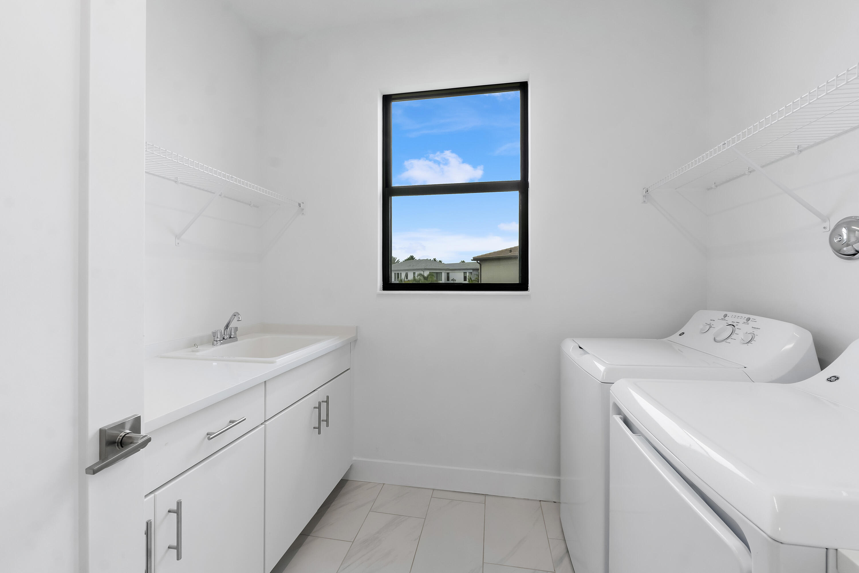 9322 Sunflower Mdw Road Boca Raton, FL 33434 - Photo 60 of 87 a utility room with dryer and washer
