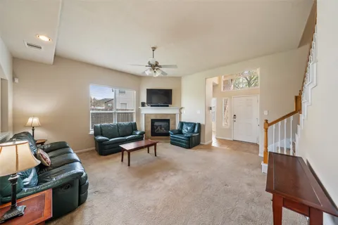 a living room with furniture a fireplace and a flat screen tv