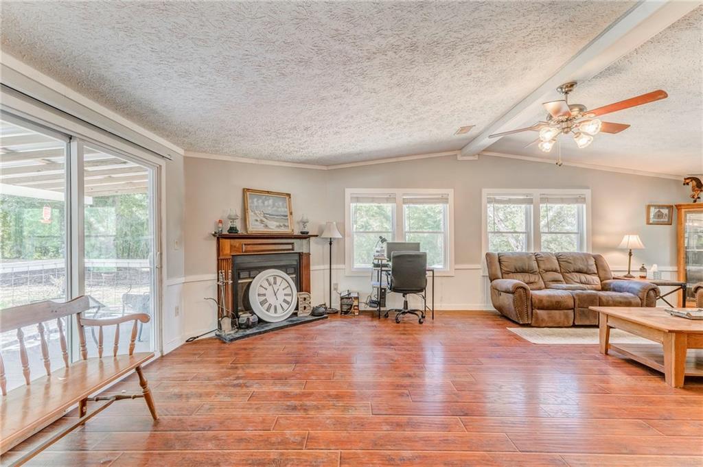 1039 Old Cedartown Road Rockmart, GA 30153 - Photo 16 of 40 a living room with furniture a fireplace and a floor to ceiling window