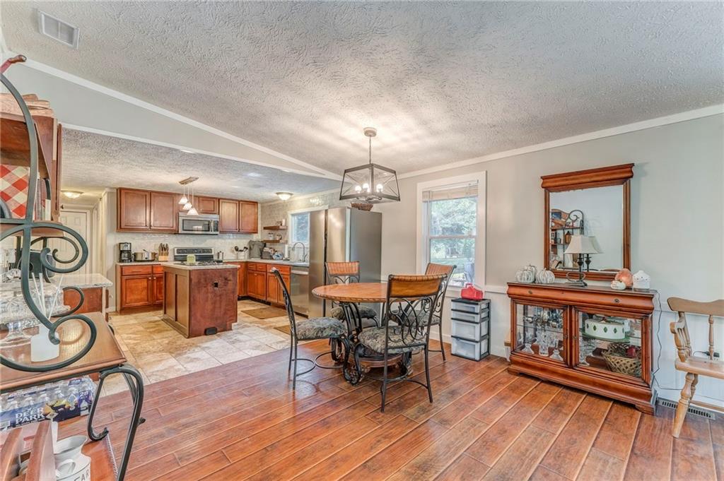 1039 Old Cedartown Road Rockmart, GA 30153 - Photo 17 of 40 a view of a dining room with furniture window and wooden floor