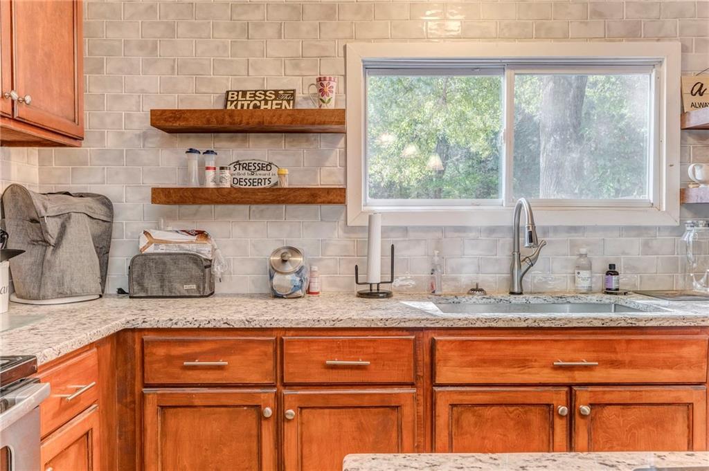 1039 Old Cedartown Road Rockmart, GA 30153 - Photo 24 of 40 a kitchen with granite countertop a sink and a window